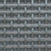 10mm Square Interwoven Grille In Antique Brass Lacquered with Floral Rosettes on Coarse Mesh